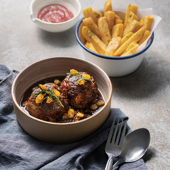 Meatballs braise d in sauce, with fries and ketchip