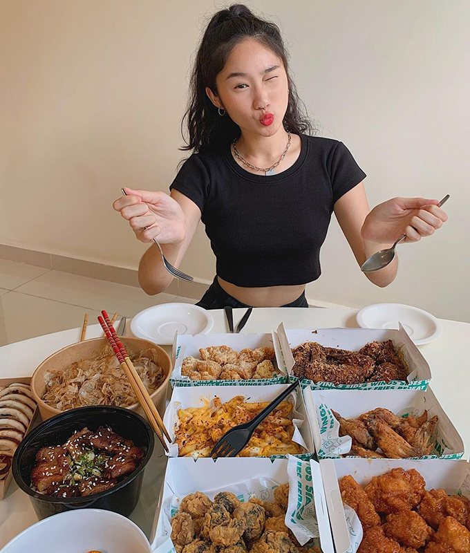 Fashion model posing with table of food