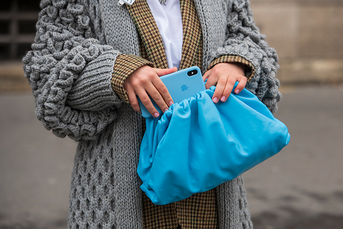 Woman putting iPhone into bag