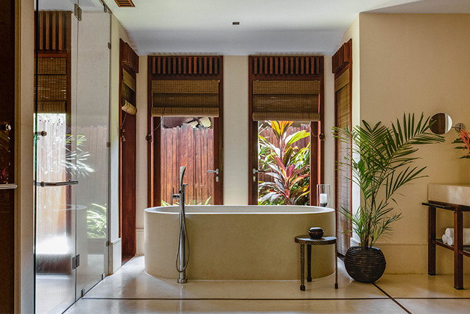 A large stone tub anchors each spacious bathroom.