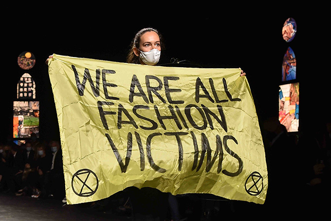 Climate change protester crashes Louis Vuitton catwalk show in Paris