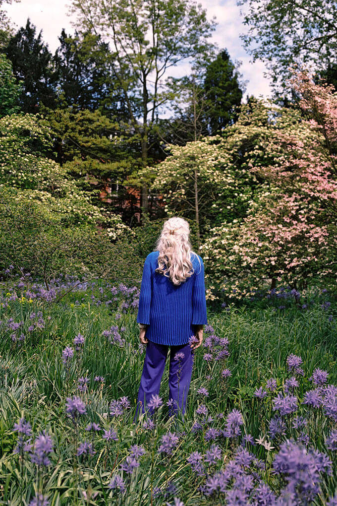 Karen Mann, MD standing in a field of flowers. Photographed by Tamara Aptekar