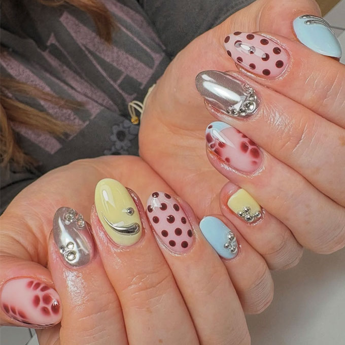 Sorbet and chrome-coloured manicure accented with polka-dots
