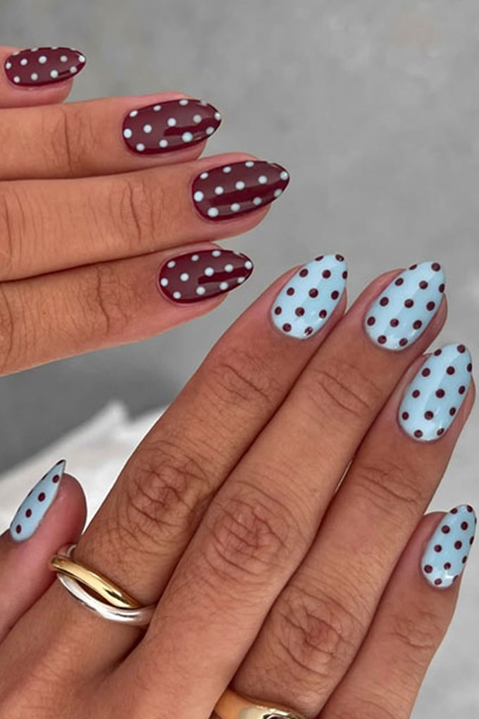 Polka-dot nails, blue and burgundy french tips, inverted on other hand