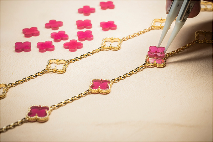 Pink Enamel four leaf clover placed into its Alhambra setting 