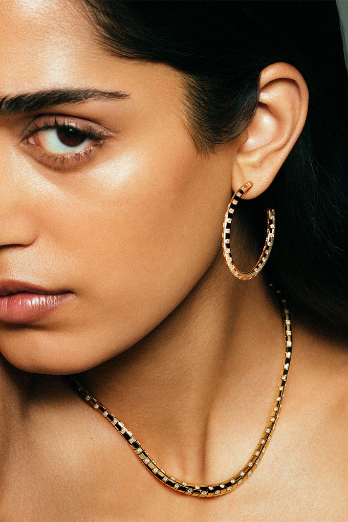 Lady wearing Le Damier de Louis Vuitton ring, sliding pendant necklace and two row diamond bracelet